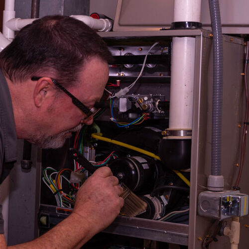 HVAC Technician Checks a Furnace.